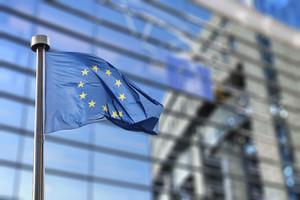 European Union flags in front of the blurred European Parliament in Brussels, Belgium